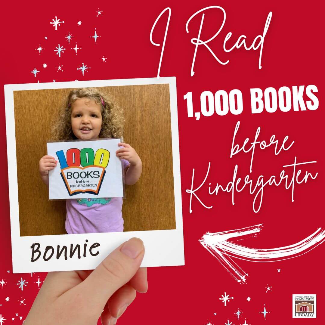 A hand holding a polaroid picture of a little girl smiling and holding a sign. The name Bonnie is written on the photo. Text to the right says I read 1,000 books before kindergarten.